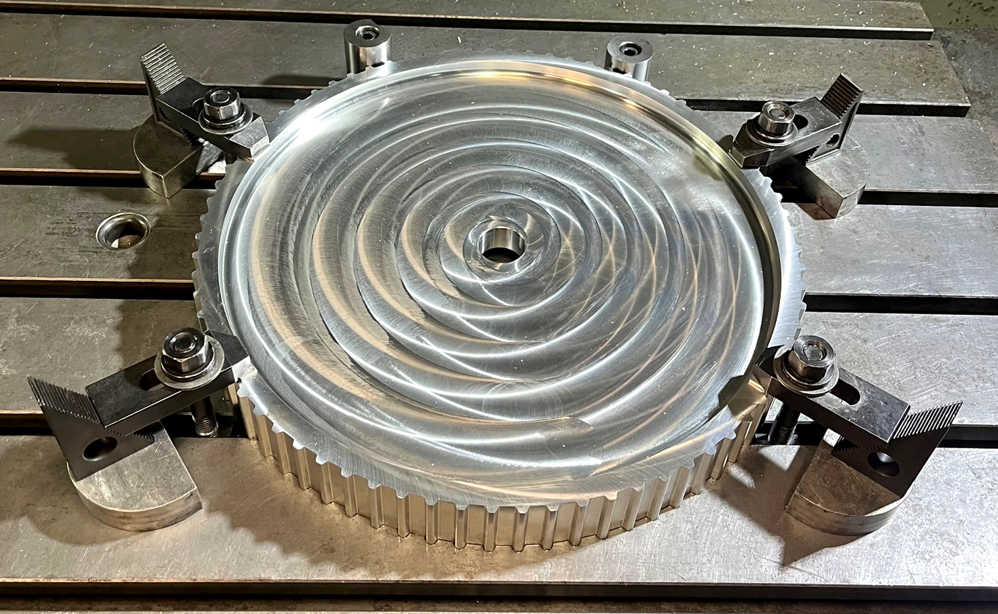 Circular metal part undergoing CNC milling